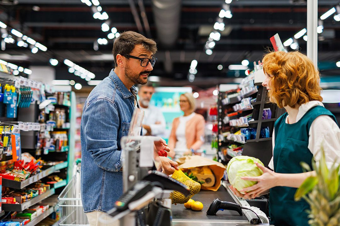 man checking out at grocery store